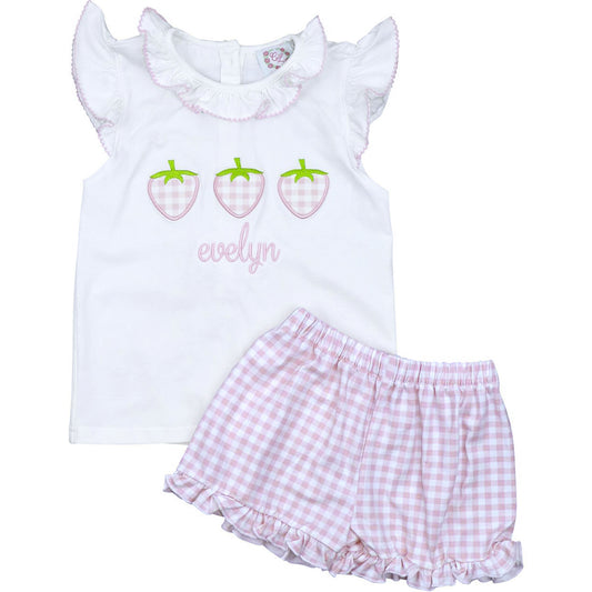 White tank top with strawberry design and checkered shorts on a white background