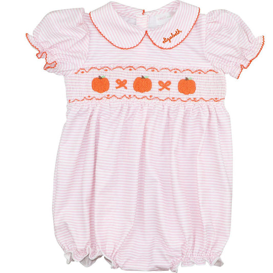 Baby romper with pumpkin and bow pattern on a white background