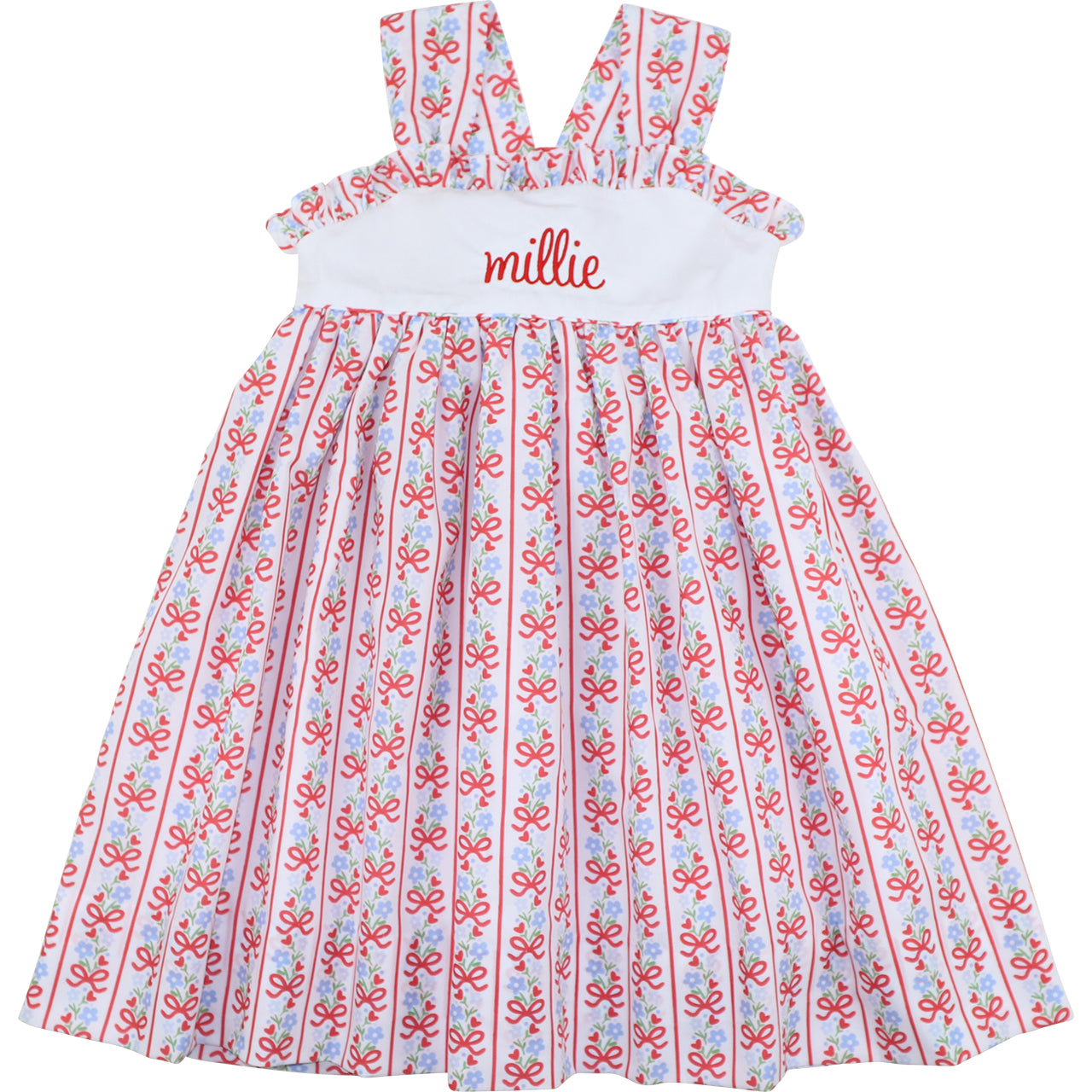 Children's dress with red and blue pattern and 'millie' embroidered on the chest.