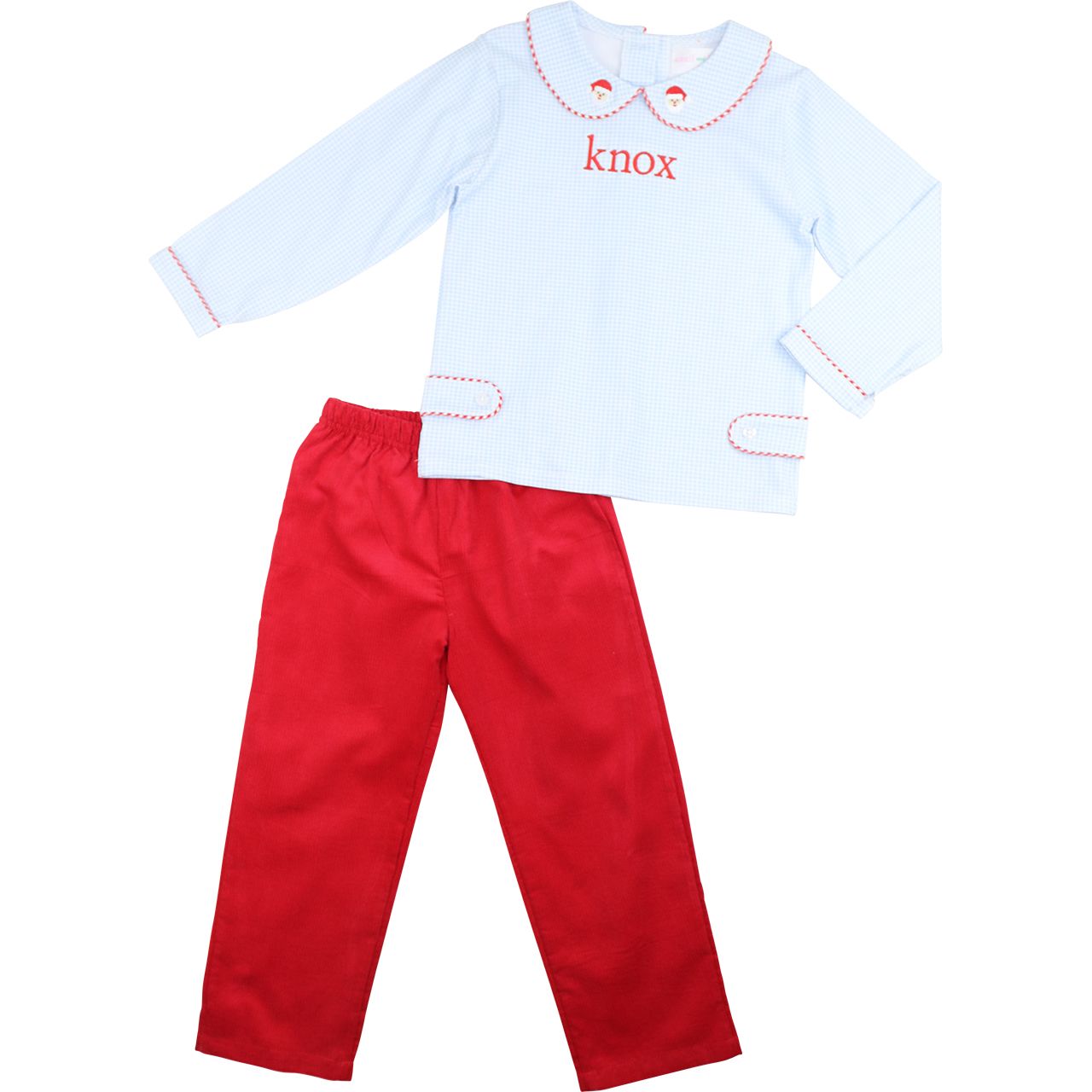 Children's outfit with light blue shirt and red pants on a white background