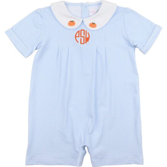 Light blue checkered short romper with white collar, orange monogram "pSw", and small orange pumpkins on a white background.