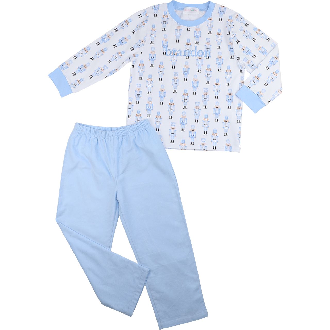 Children's pajama set with patterned top and solid pants on a white background
