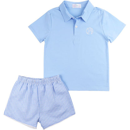 Light blue polo shirt and checkered shorts set on a white background
