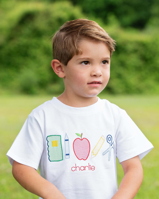 Boy wearing a school themed shirt.