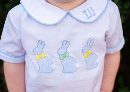 Child's shirt with embroidered bunnies and monogram on a blurred background