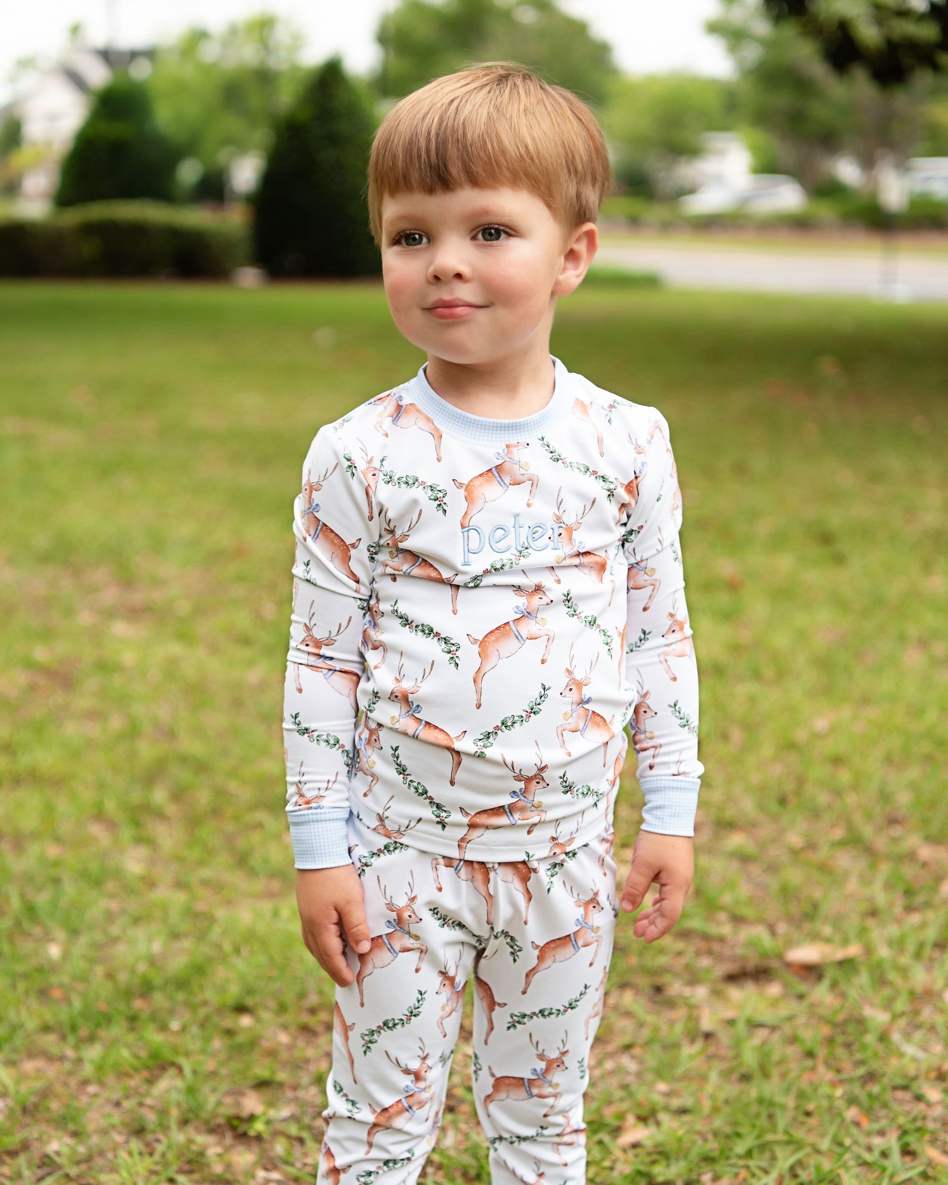 Child wearing a long-sleeve shirt and pants with fox pattern outdoors