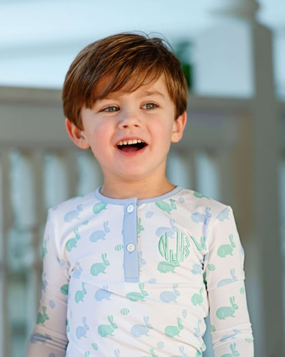 Child wearing a long-sleeve shirt with turtle pattern outdoors