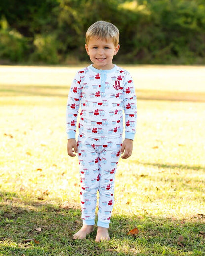 Child wearing a pajama set with red and white pattern outdoors