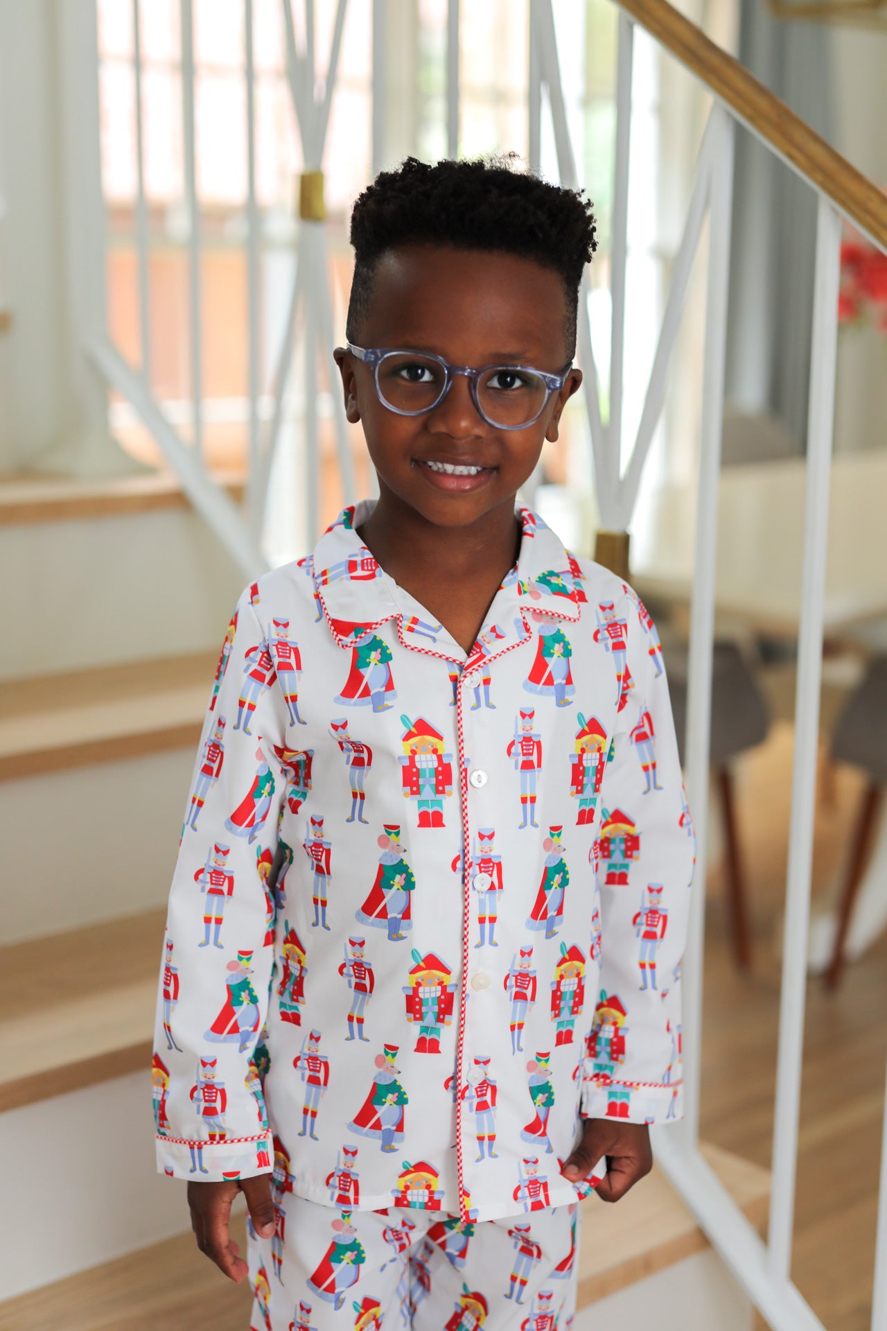 Child wearing a patterned nutcracker pajama set indoors