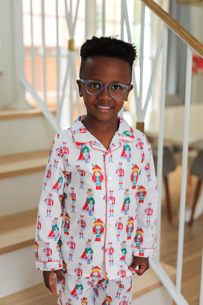 Child wearing a patterned nutcracker pajama set indoors