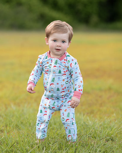 Child wearing a patterned outfit standing in a grassy field