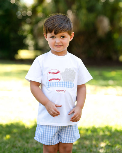 Child wearing a white t-shirt with a graphic design and text, standing outdoors.