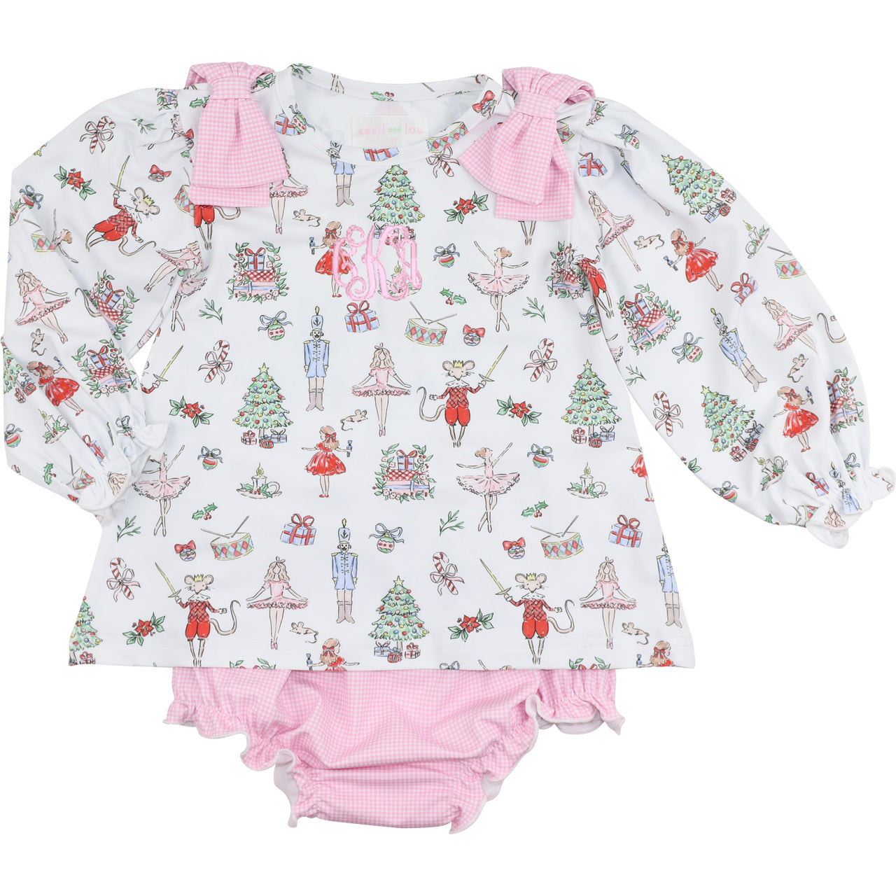 Children's outfit with long-sleeve top and pink bloomers featuring a festive nutcracker pattern on a white background.