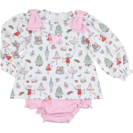 Children's outfit with long-sleeve top and pink bloomers featuring a festive nutcracker pattern on a white background.