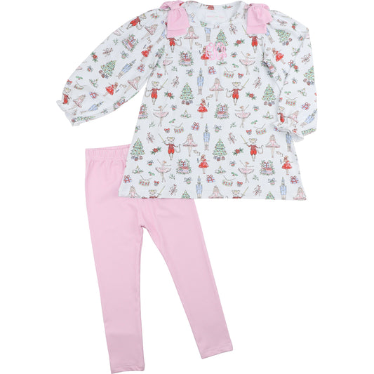 Children's outfit with patterned top and pink leggings on a white background