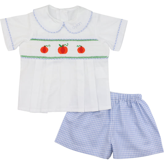 Children's outfit with white shirt and blue checkered shorts on a white background