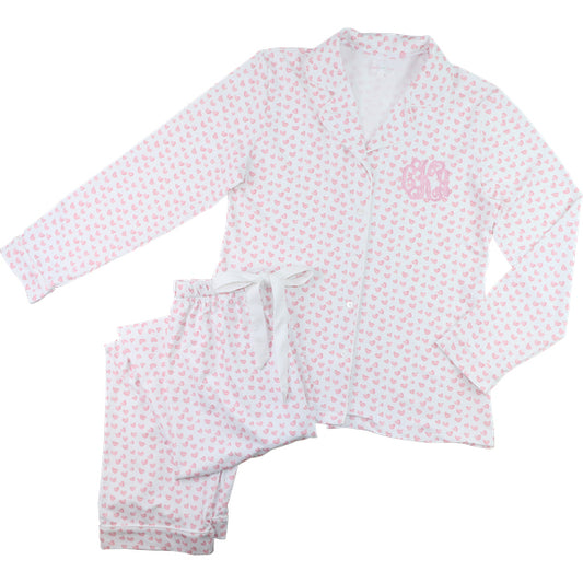 Children's pajama set with pink and white heart pattern on a white background