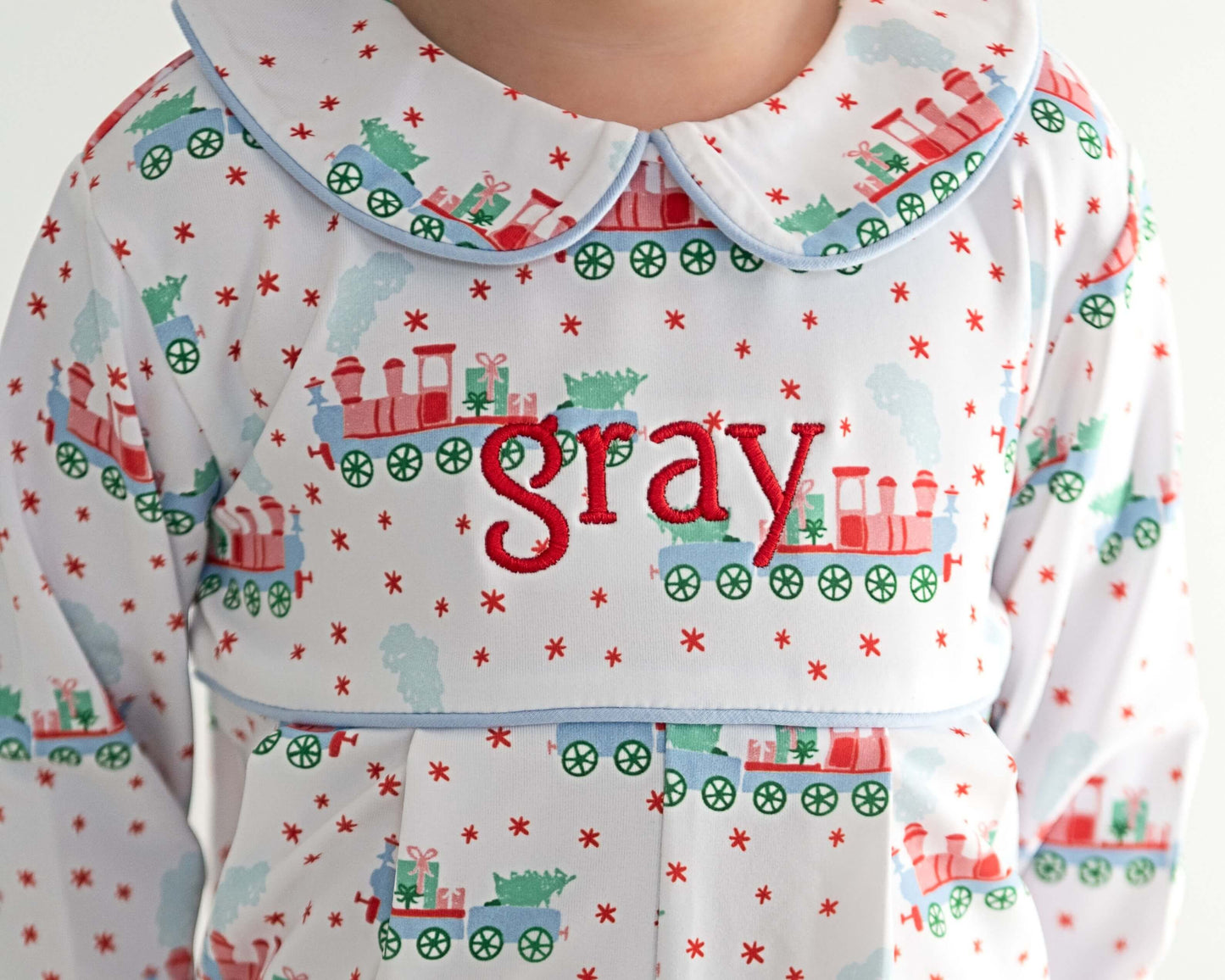 Children's pajama set with train pattern and 'gray' text on a white background