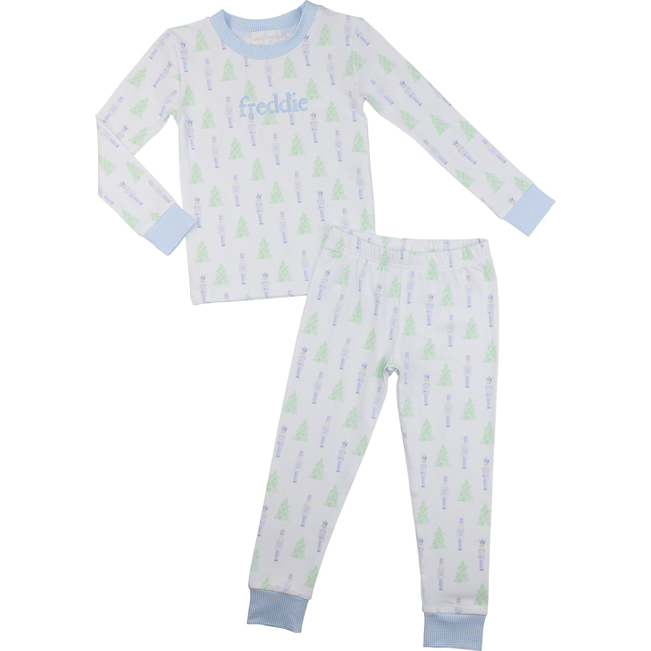 Children's pajama set with tree pattern and 'freddie' monogram on a white background
