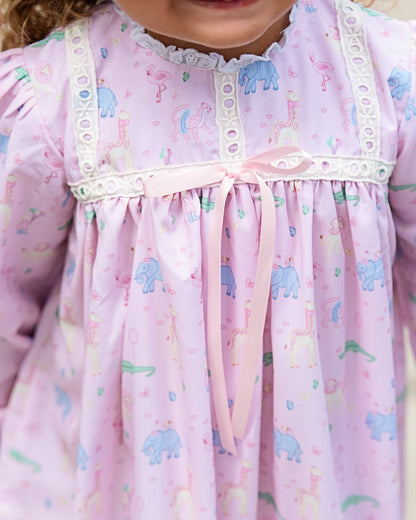 Close-up of a child's pink nightgown with birthday animal prints