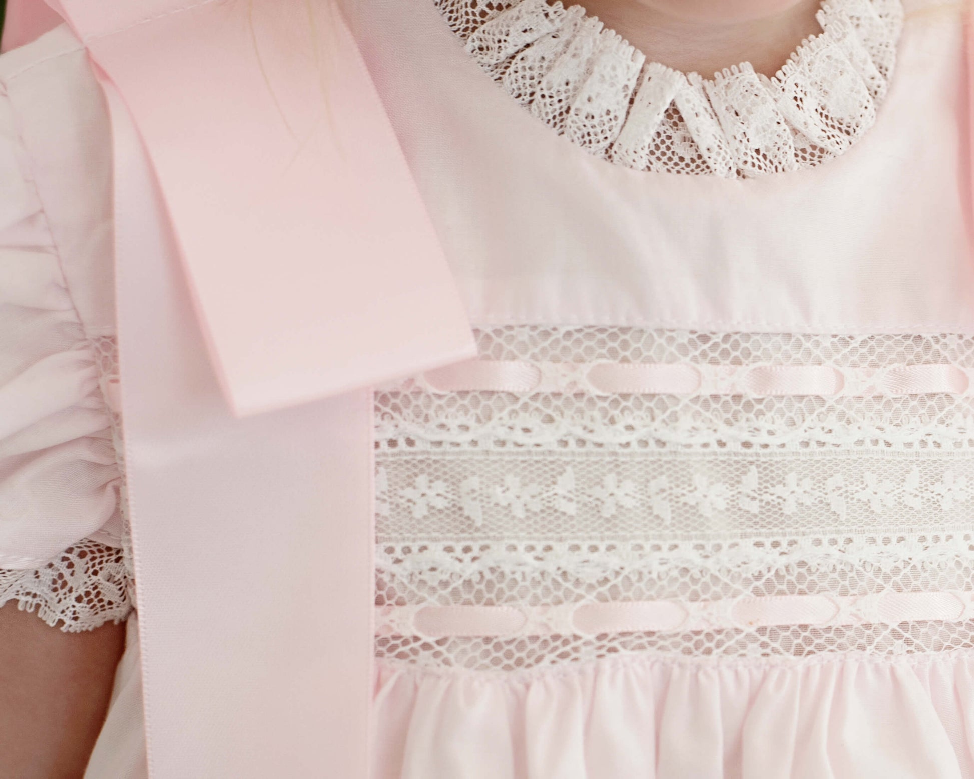 Close-up of a pink dress with lace details