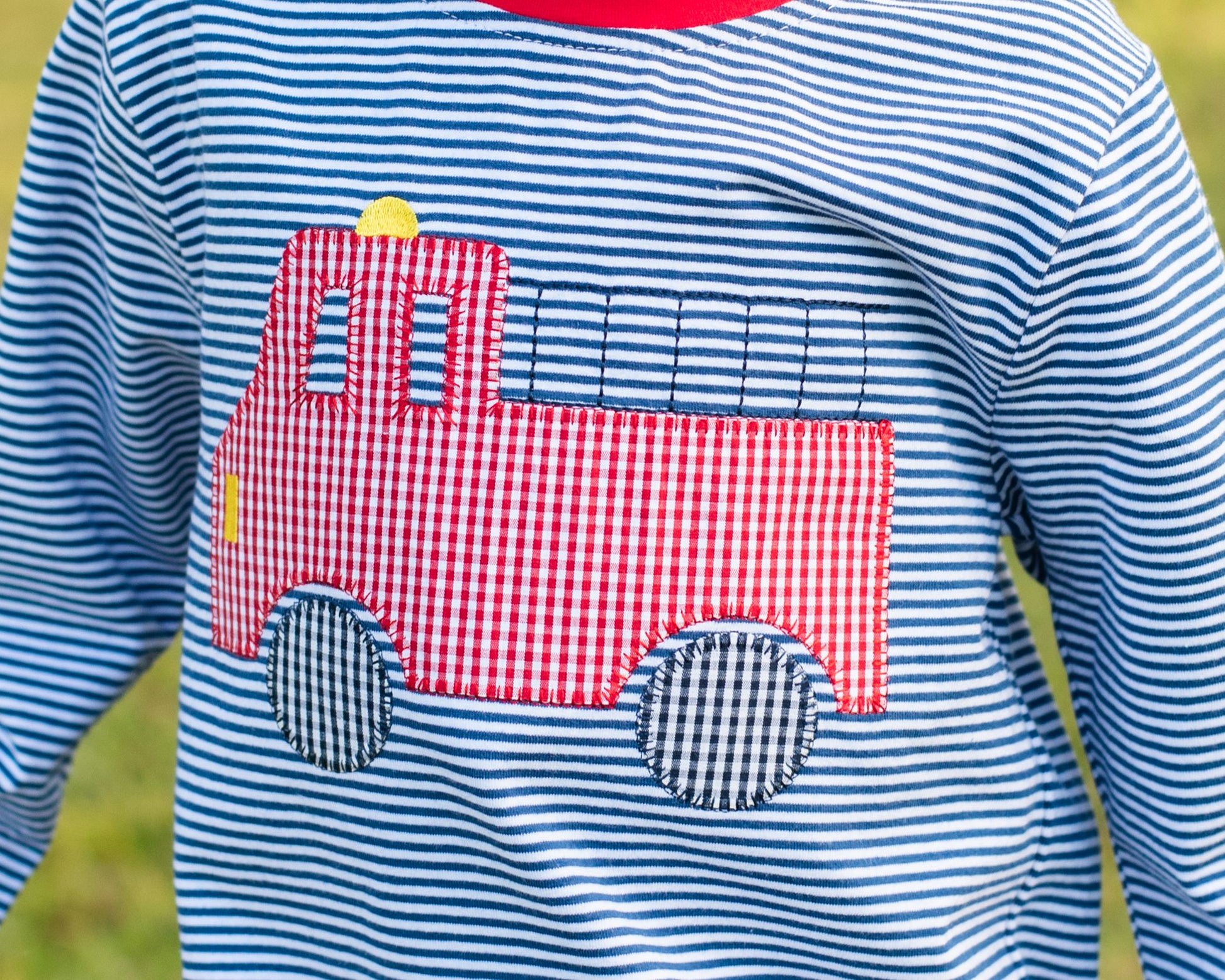 Close up of Navy And Red Striped Knit Applique Firetruck Shirt