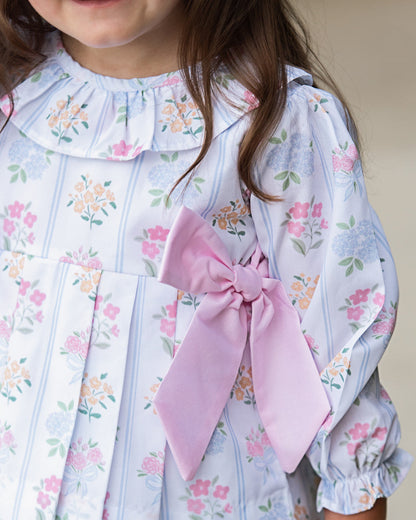 Close up of Young girl wearing Pink And Blue Floral Bouquet Diaper Set