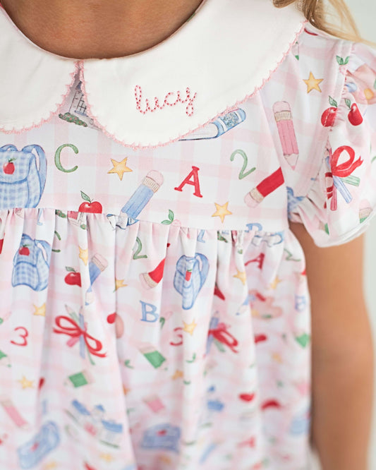Close up of a dress with back to school designs