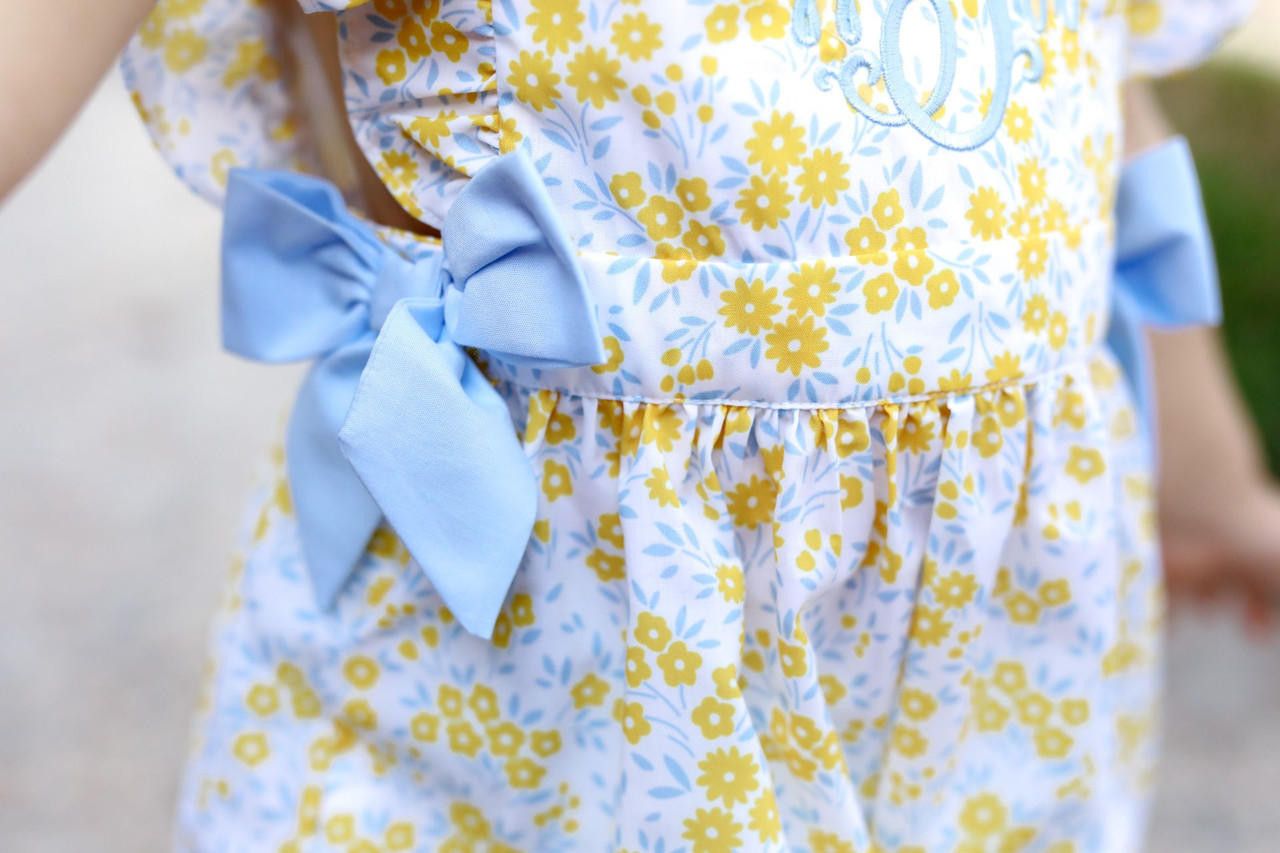 Close up of a floral outfit with blue side bows