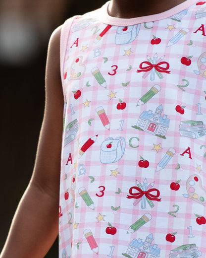 Close up of a young child wearing a school themed outfit. 