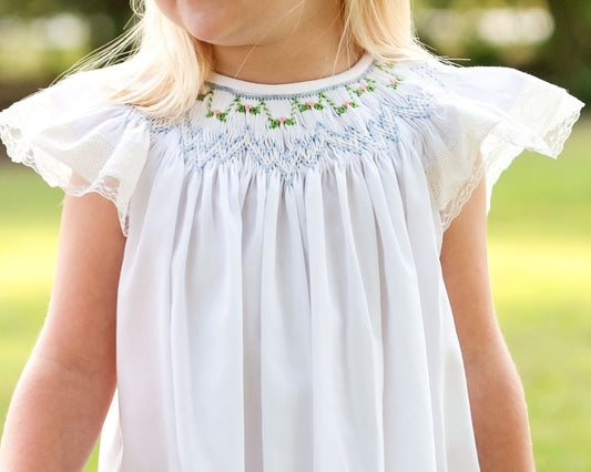 Close up of delicate smocking on a white dress