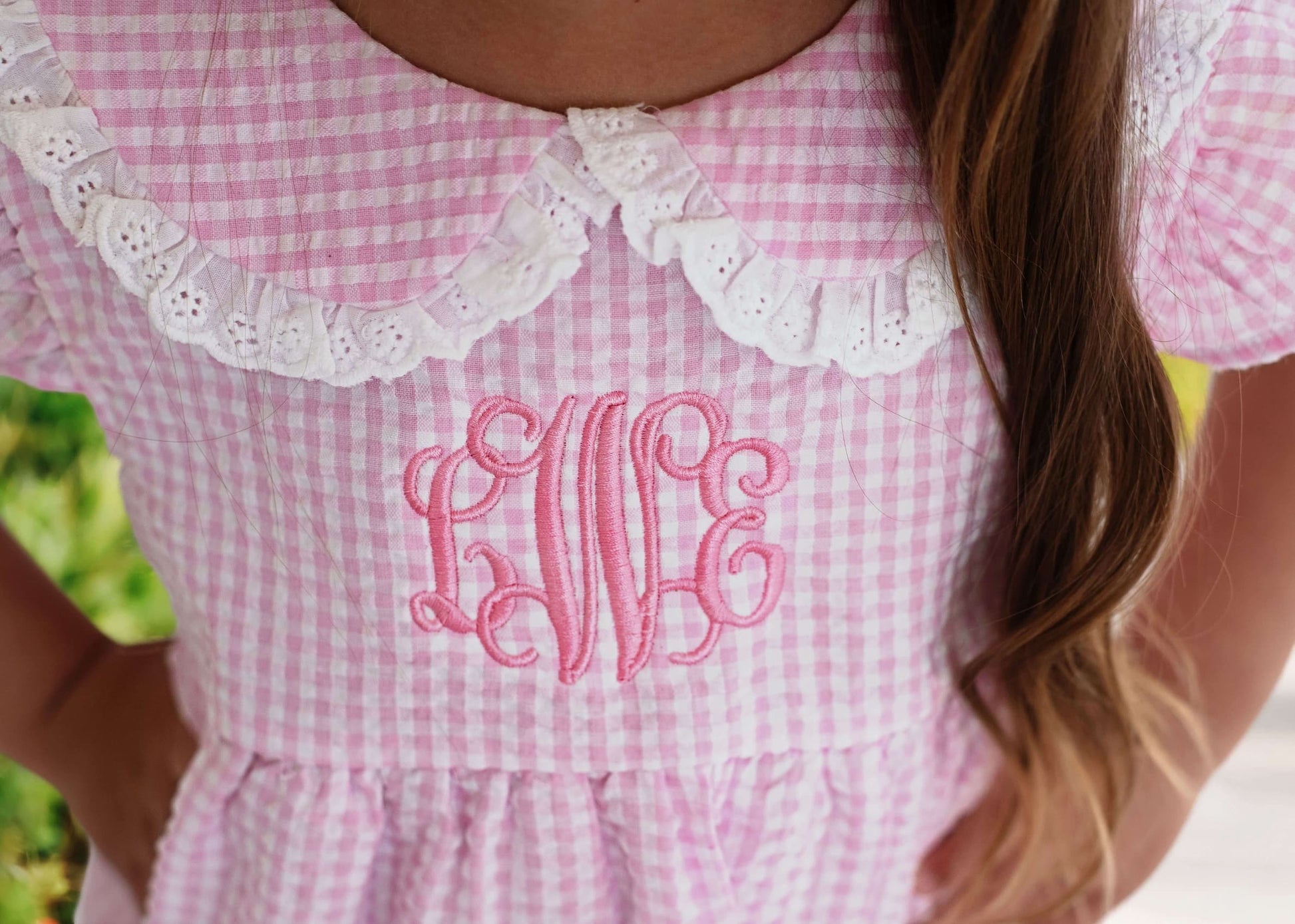 Close up of monogramming on a pink gingham bubble
