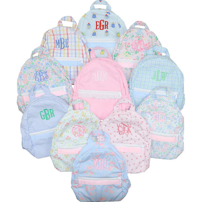 Collection of colorful backpacks with monogramming on a white background