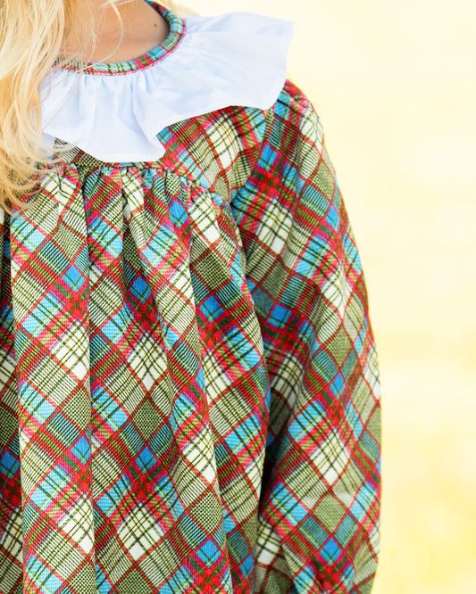 Colorful plaid dress with a white collar on a yellow background