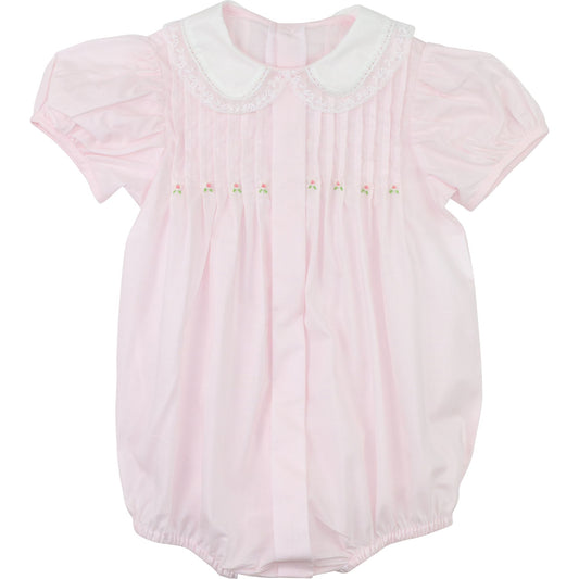 Pink baby girl bubble romper with white Peter Pan collar, embroidered rosebuds, and pleated bodice on flat lay