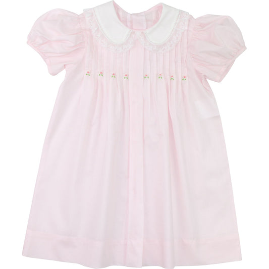 Girls pink heirloom dress with white Peter Pan collar, puff sleeves, embroidered rosebuds, flat lay view