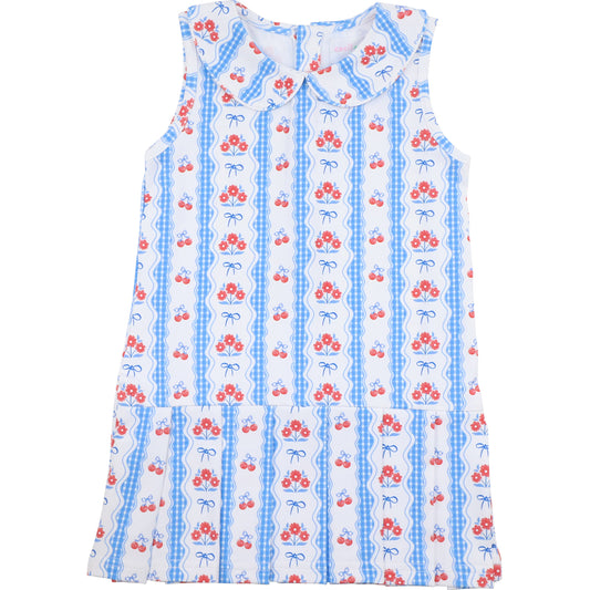 Sleeveless tennis dress with cherry and bow pattern on a white background