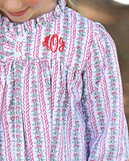 Floral dress with red monogram on a blurred background