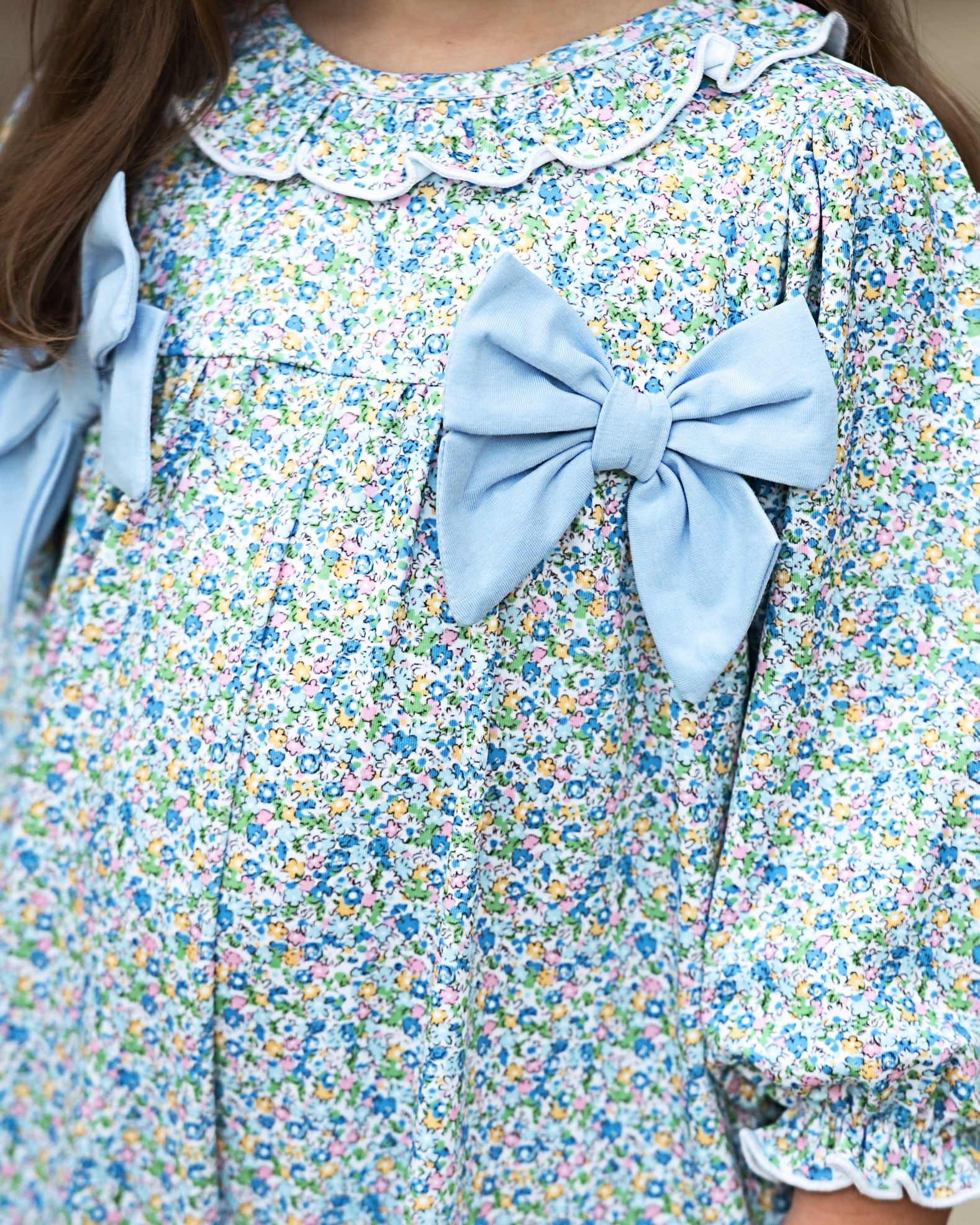 Floral long bubble with a large blue bow on a blurred background
