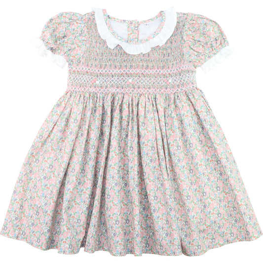 Floral smocked dress with a white collar on a white background