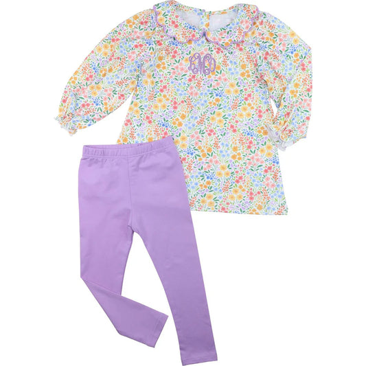 Floral top and purple pants set on a white background