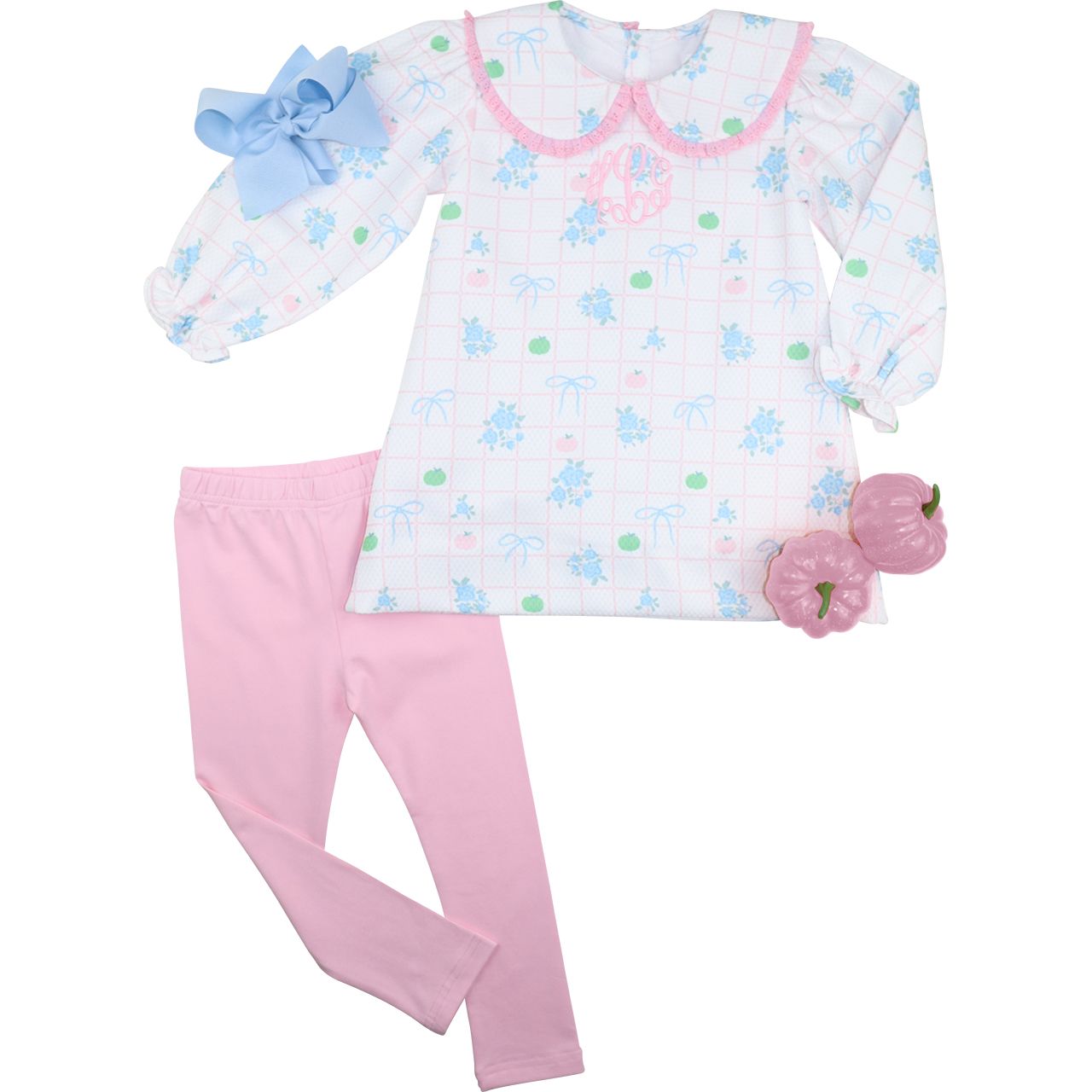 Girl outfit with a patterned top, pink pants, and accessories on a white background