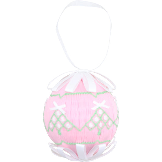Pink smocked Christmas trees on an ornament on a white background