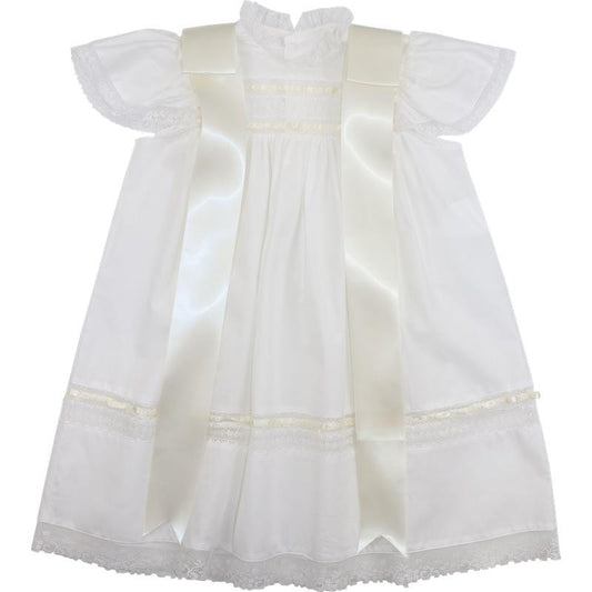 Ivory heirloom dress for girls featuring delicate lace trim, flutter sleeves, and elegant satin bows. A timeless special occasion dress ideal for christenings, blessings, and formal portraits.