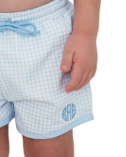 Light blue checkered shorts with a monogram on a white background