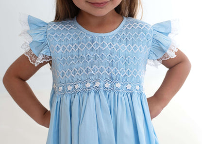 Light blue dress with lace details on a white background