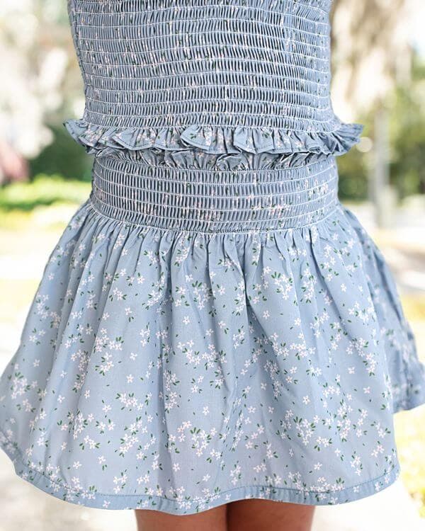 Light blue floral skirt set with a blurred outdoor background