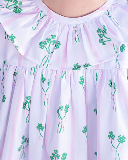 Light purple dress with green floral patterns on a white background