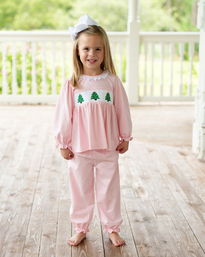 Little girl standing outside wearing a Pink Knit Smocked Christmas Tree Pant Set