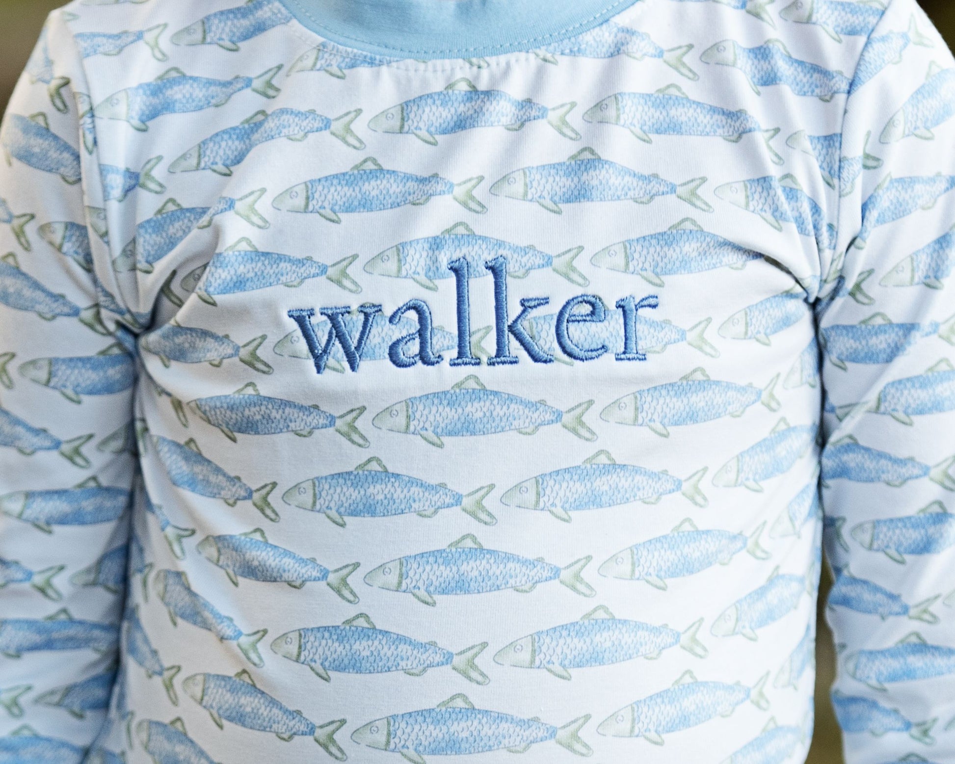 Long-sleeve shirt with fish pattern and 'walker' text on a light blue background